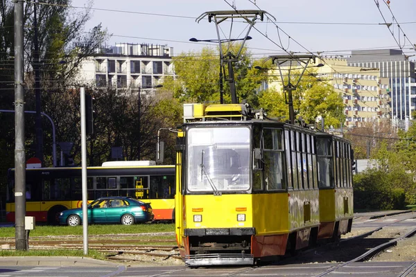 Żółte, jasne, nowoczesne tramwaje zbliżeniowe w słonecznej pogodzie w jesienno-europejskim mieście Warszawa. Wygodny transport publiczny — Zdjęcie stockowe