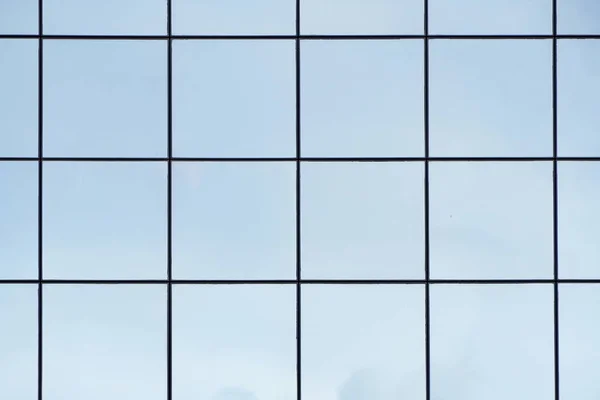 Glass with mirror effect in frames, facing of modern office building