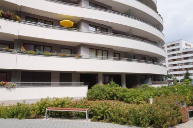 Krakow, Poland - 08.01.2019: loggias of modern apartment house of the non-standard form, the bent walls. the use of colors in the decoration of fences. cozy courtyard of a high-rise building.