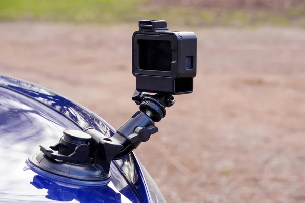 Action camera mounted on the back of a blue car. Shooting a car in motion.