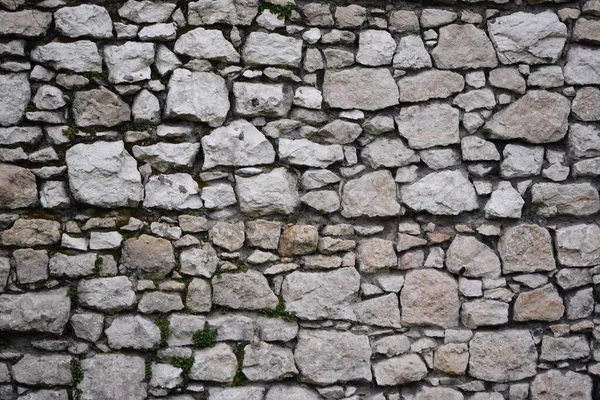Stone wall, large gray stones, the civil and industrial construction.
