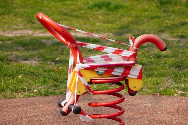 Indoor Playground for children a carousel and swings. B an o n children \'s playgrounds. Prevention of coronavirus. The fight against the virus. No children on the Playground in the yard.