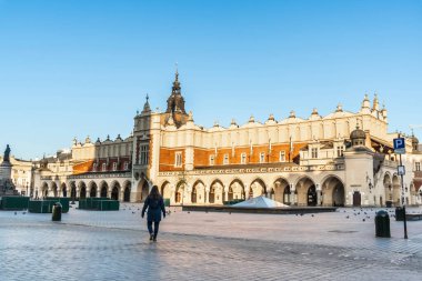 Krakow, Polonya 20.04.2020: boş, şehir merkezindeki ana pazar meydanı şafak vakti mavi bulutsuz bahar gökyüzüne karşı. Turist yok, kapalı restoranlar ve dükkanlar yok. Kapalı durum sınırları