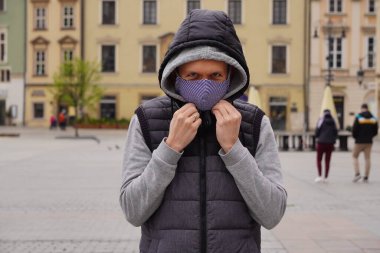 Adam eski binaların yanında tıbbi maskeler takıyor. Boş meydan, turistlere sosyal uzaklık. Koronavirüs ve karantinadan sonra ülkeyi açın