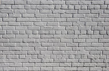 Güneş ışığında dokulu arka plan boyalı beyaz tuğla duvar
