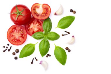 Whole and sliced tomato with basil leaves and garlic, spice, located around the edges for design isolated on white background