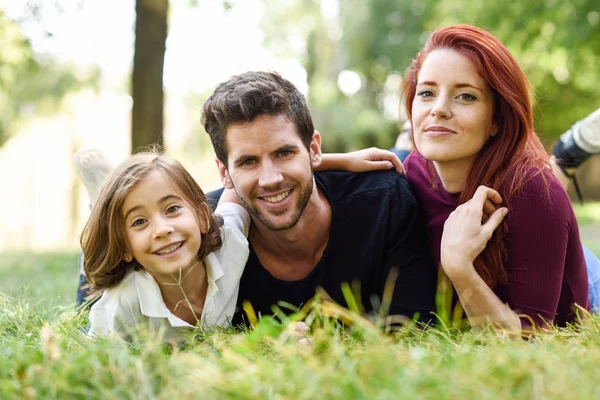 Happy young family in a urban park — Stock Photo, Image