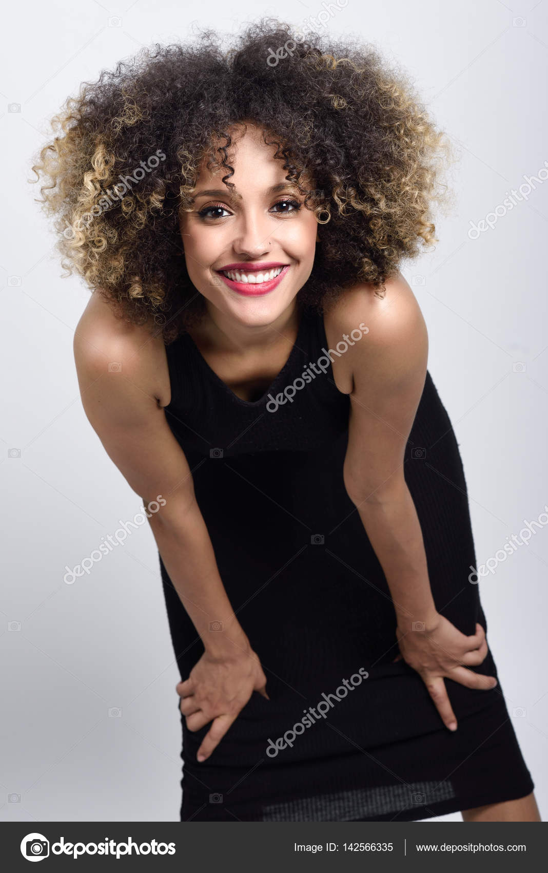 Young Black Woman With Afro Hairstyle Smiling Stock Photo