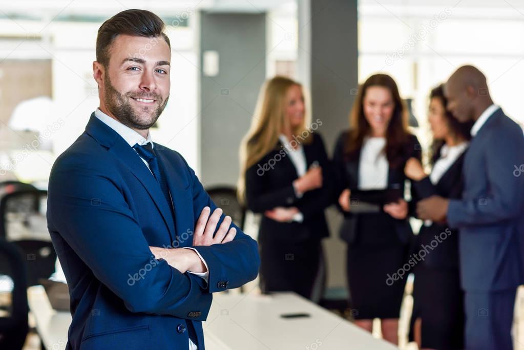 Businessman leader in modern office with businesspeople working 
