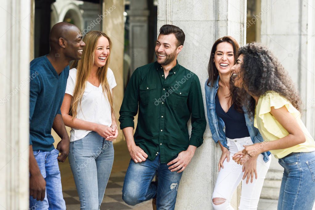 Multi-ethnic group of friends having fun together in urban backg