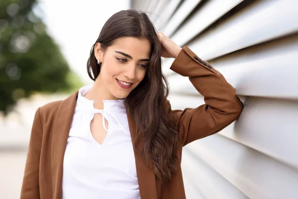 Young woman with nice wavy long hair wearing formal wear. — Stock Photo, Image