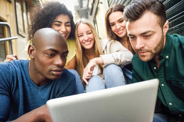 Багатоетнічна група молодих людей дивиться на планшетний комп'ютер — стокове фото