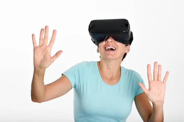 Woman looking in VR glasses and gesturing with his hands. — Stock Photo, Image
