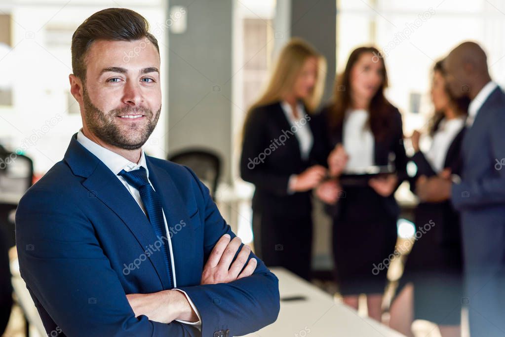 Businessman leader in modern office with businesspeople working 