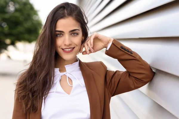 Formal giyim giymiş güzel dalgalı uzun saçlı genç kadın. 