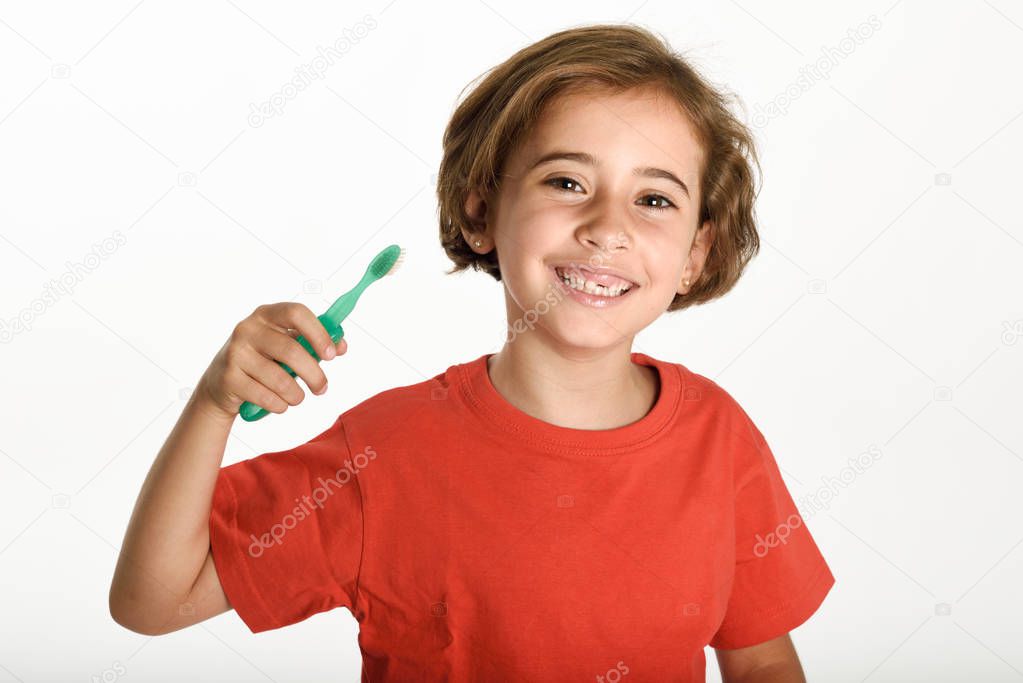 Happy little girl brushing her teeth with a toothbrush