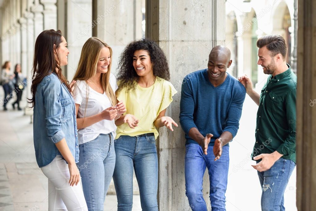 Multi-ethnic group of friends having fun together in urban backg