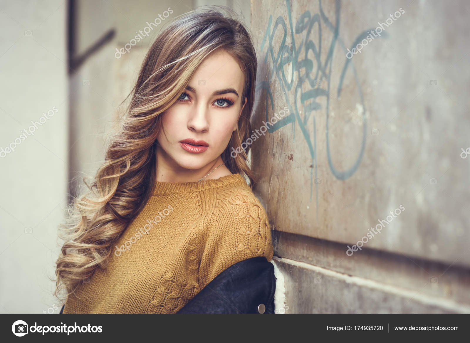 Beautiful blonde russian woman in urban background Stock Photo by ©javiindy  174935720