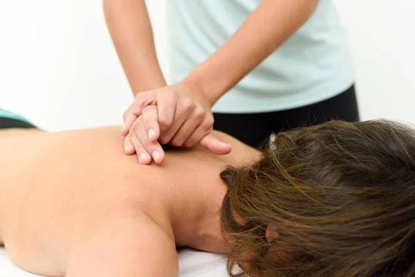 Young woman receiving a back massage in a spa center. — Stock Photo, Image