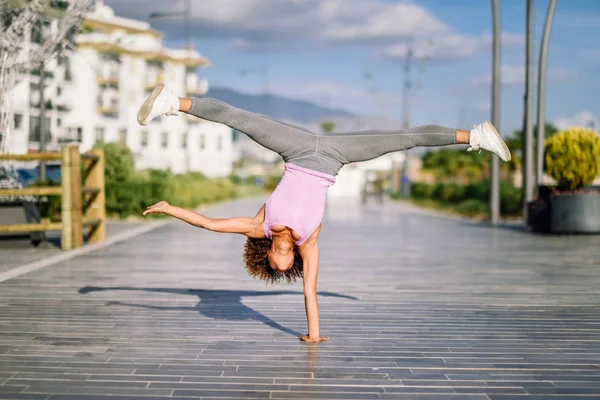 Nero in forma donna fare fitness acrobazie in urbano sfondo — Foto Stock