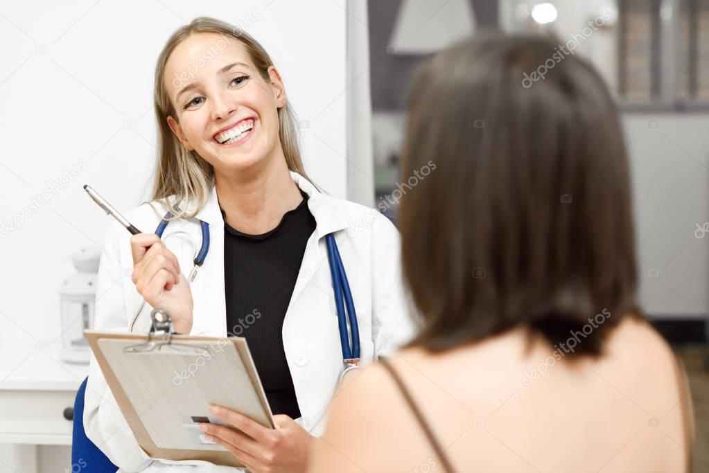 Female doctor explaining diagnosis to her young woman patient.