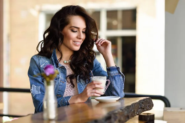 Kvinna sitter inomhus i urban café casual kläder — Stockfoto