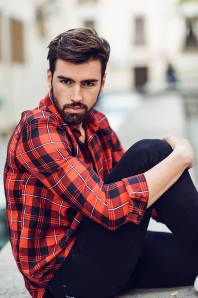 Young bearded man, model of fashion, wearing a plaid shirt with — Stock Photo, Image