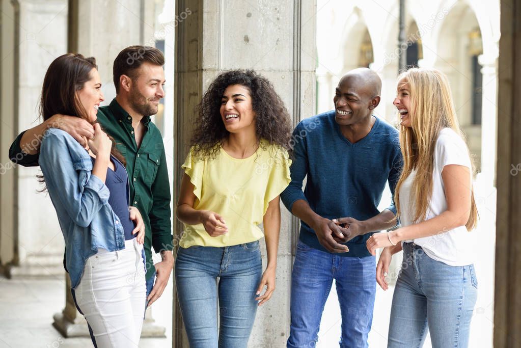 Multi-ethnic group of friends having fun together in urban backg