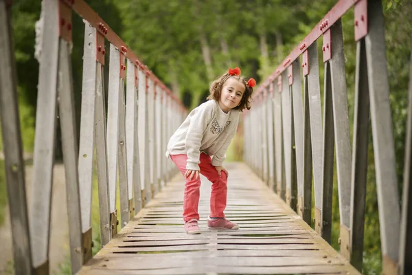 Cute little girl having fun in a rural bridge — Stock Photo, Image