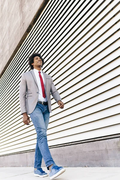 Black Businessman wearing suit walking in urban background. — Stock Photo, Image