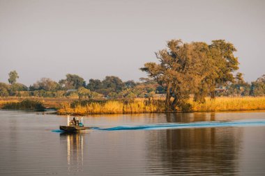 Chobe National Park, Botswana - August 1 2019: Small Tourist Game Spotting Boat Cruising on Chobe River, Botswana, Africa.