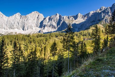 bright sky in the mountains look into the alps and a valley near a glacier dachstein