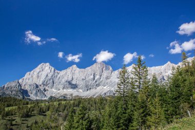 bright sky in the mountains look into the alps and a valley near a glacier dachstein