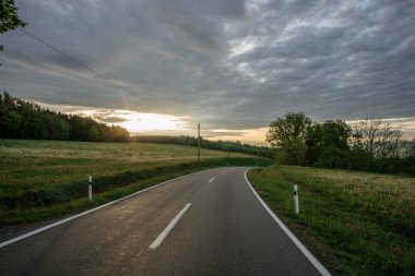 roadtrip with a dramatic sky and unknown destination