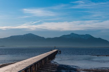 beautiful bright day on a lake walking on the pier