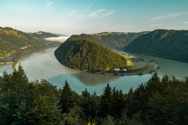 scenic view of mountain surrounded by river at daytime