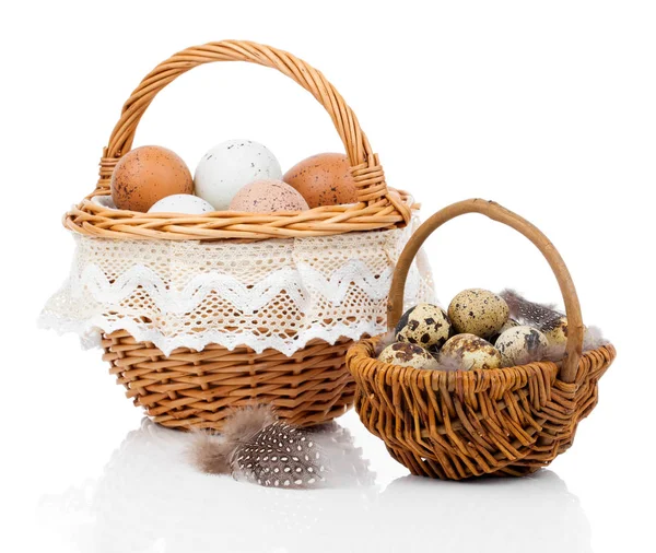 Basket with eggs and quail eggs on a white background — Stock Photo, Image