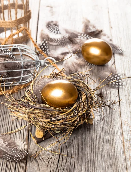 Golden egg of chickens in nest, on wooden background Stock Image