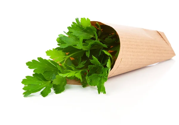 Bundle of parsley in a paper package on a white background — Stock Photo, Image
