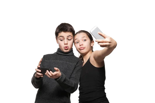 Teenage boy and girl with their smart phone — Stock Photo, Image