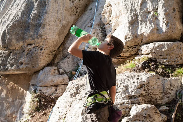Young rock climber drinks water — Stock Photo, Image