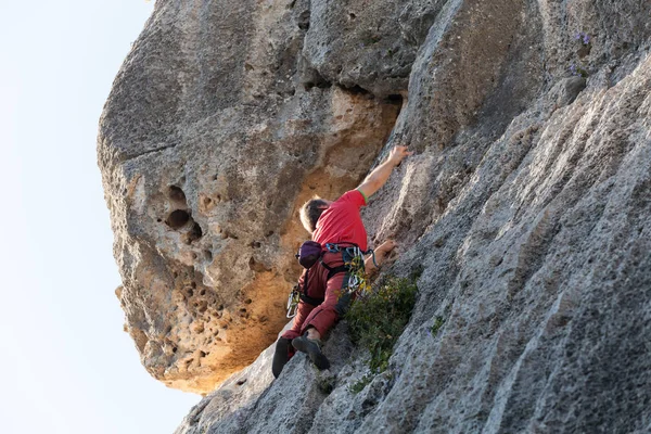 Man climbing on a limestone wall — Stock Photo, Image