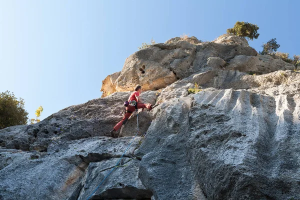 Man climbing on a limestone wall — Stock Photo, Image