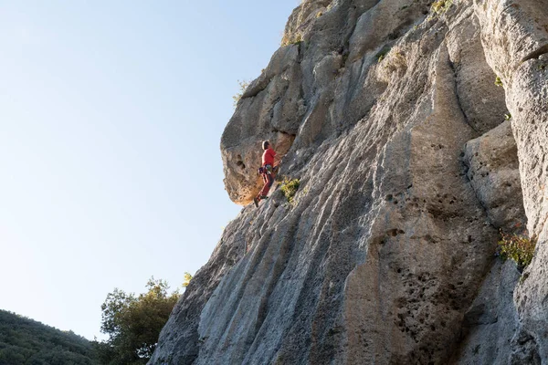 Man climbing on a limestone wall — Stock Photo, Image