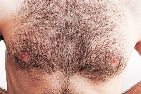 Boy with naked hairy chest on white background