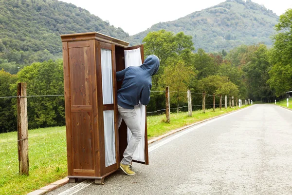 Persona in una situazione strana, guardare fuori dall'armadio nel mezzo — Foto Stock