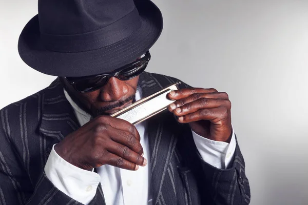 Musician plays the harmonica — Stock Photo, Image