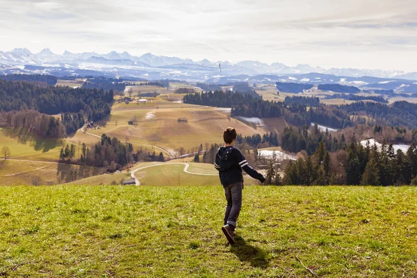 Boy throws stick, mountain landscape, the concept of anger — Stock Photo, Image