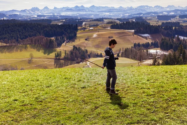 Boy throws stick, mountain landscape, the concept of anger — Stock Photo, Image