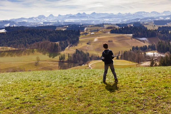 Boy standing behind me watching the mountain landscape — Stock Photo, Image